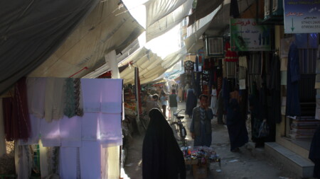 People at a city market, a woman in the foreground